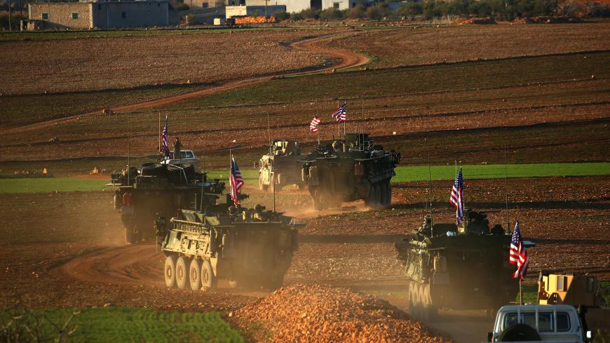 TOPSHOT - A convoy of US forces armoured vehicles drives near the village of Yalanli, on the western outskirts of the northern Syrian city of Manbij, on March 5, 2017. / AFP PHOTO / DELIL SOULEIMAN        (Photo credit should read DELIL SOULEIMAN/AFP/Getty Images)