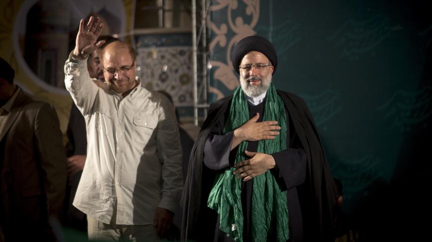 IRAN, TEHRAN - MAY 16:  Iranian presidential candidate Ebrahim Raisi (R) holds hands with former presidential candidate and mayor of Tehran, Mohammad Bagher Ghalibaf (C), as he greets his supporters during a campaign rally at Imam Khomeini Mosque in the capital Tehran on May 16, 2017 in Tehran, Iran.  Iran's presidential election on May 19 is effectively a choice between moderate incumbent Hassan Rouhani and hardline jurist Raisi, with major implications for everything from civil rights to relations with Wa