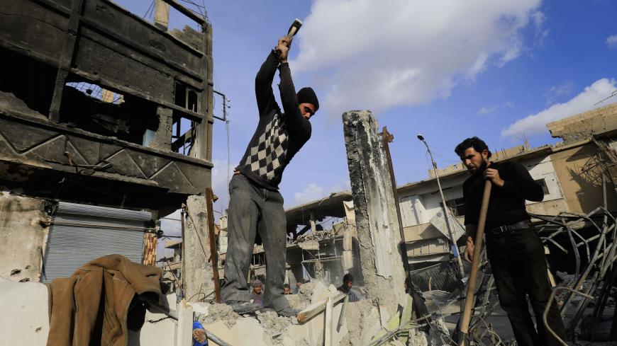 Syrian men work on reconstructing a damaged building in the northern Syrian city of Raqa, on January 16, 2018 after a huge military operation led on the ground by Kurdish fighters and in the air by US warplanes defeated jihadists from the Islamic State group but also left the city completely disfigured.
Once home to around 300,000 people, Raqa's neighbourhoods were empty when it was declared retaken in mid-October. Three months on, despite the lack of infrastructure and the lingering threat of unexploded mi