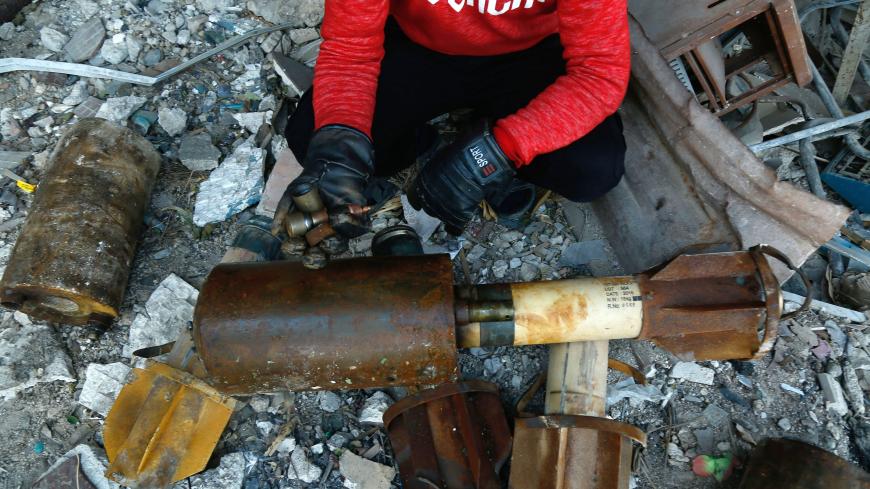 A Syrian man shows remnants of rockets reportedly fired by regime forces on the rebel-held besieged town of Douma in the eastern Ghouta region on the outskirts of the capital Damascus on January 22, 2018. 
At least 21 cases of suffocation, including children, were reported in Syria in a town in eastern Ghouta, a beleaguered rebel enclave east of Damascus, an NGO accusing the regime of carrying out a new chemical attack said. Since the beginning of the war in Syria in 2011, the government of Bashar al-Assad 