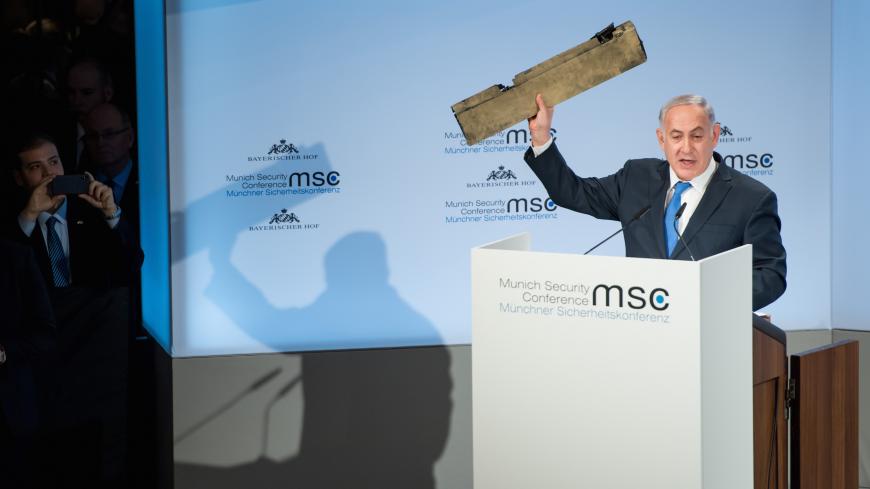 MUNICH, BAVARIA - FEBRUARY 18:  In this handout photo Israeli Prime Minister Benjamin Netanyahu holds up what he claims is a piece of an Iranian drone that was shot down after it flew over Israeli territory at the 2018 Munich Security Conference on February 18, 2018 in Munich, Germany. The annual conference, which brings together political and defense leaders from across the globe, is taking place under heightened tensions between the USA, together with its western allies, and Russia.  (Photo by Lennart Pre