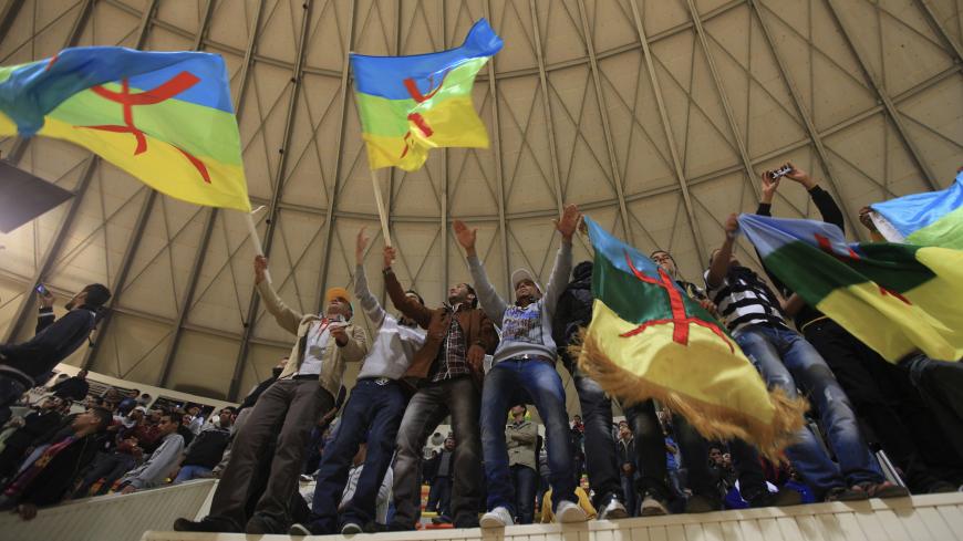 Members of the audience wave Amazigh flags during Libya's first festival of the Amazigh songs in Benghazi December 15, 2011. REUTERS/Esam Al-Fetori (LIBYA - Tags: POLITICS SOCIETY TPX IMAGES OF THE DAY) - GM1E7CG0KSM01