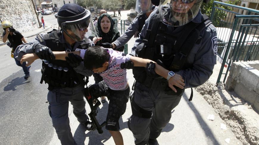 A Palestinian woman yells as Israeli police detain a boy during minor clashes between Palestinian stone-throwers and police in the East Jerusalem neighbourhood of Issawiya May 15, 2012. Israeli security forces were on high alert for violence on Tuesday, the day when Palestinians mark "Nakba", or catastrophe, of Israel's founding in a 1948 war, when hundreds of thousands of their brethren fled or were forced to leave their homes. REUTERS/Ammar Awad (JERUSALEM - Tags: POLITICS CIVIL UNREST ANNIVERSARY) - GM1E