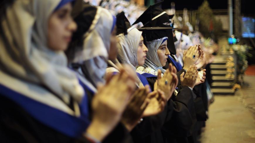 Palestinian students attend their graduation ceremony at the University College of Applied Sciences in Gaza City September 10, 2014. REUTERS/Ibraheem Abu Mustafa (GAZA - Tags: EDUCATION) - GM1EA9B0BV901