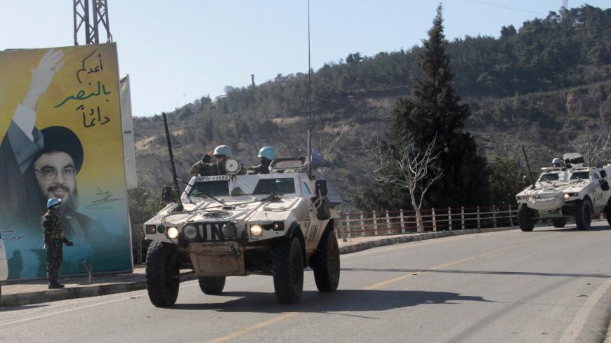 U.N. peacekeepers of the United Nations Interim Force in Lebanon (UNIFIL) patrol near the Lebanese-Israeli border as they drive past a picture of Lebanon's Hezbollah leader Sayyed Hasan Nasrallah in Adaisseh village, southern Lebanon January 29, 2015. Two Israeli soldiers and a Spanish peacekeeper were killed when Hezbollah fired a missile at a convoy of Israeli military vehicles at the Lebanon border. A U.N. spokesman and Spanish officials said the peacekeeper was killed as Israel responded with air strike