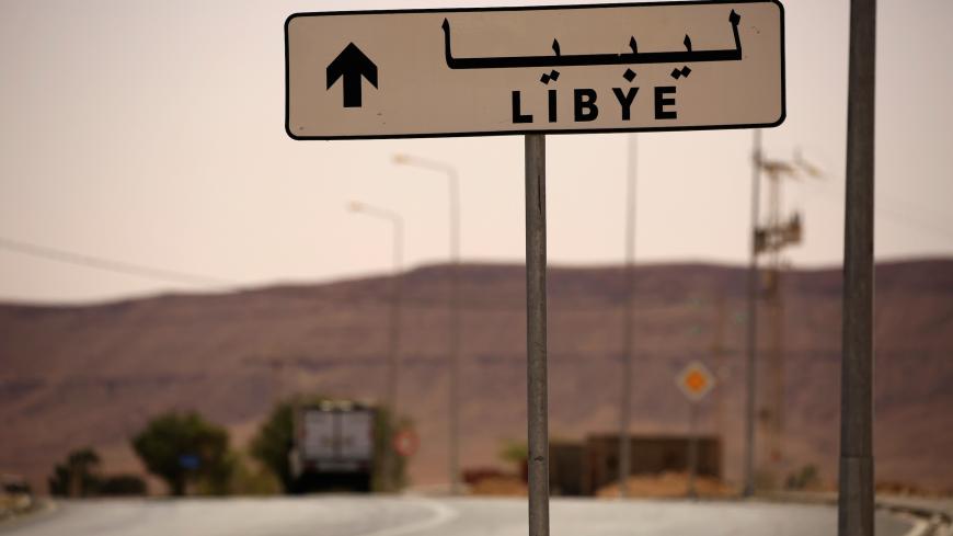 A road sign shows the direction of Libya near the border crossing at Dhiba, Tunisia April 11, 2016.  Tunisia's 2011 uprising created fertile ground for jihadist recruiters. Hundreds of Islamist militants were freed from prison as part of an amnesty for those detained under Ben Ali. Ultra-conservative salafists began to flex their muscle, seizing control of mosques and clashing with secularists. As Tunisia's politics have stabilised, the government has reasserted control, taking back mosques, banning the loc