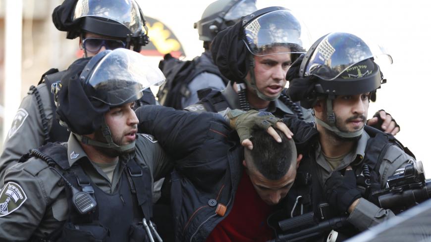 Israeli border policemen detain a Palestinian protester during clashes near Jerusalem's Old City December 26, 2015. Palestinians protested demanding that they be given the bodies of their brethren who have been killed during the latest wave of violence with Israel. REUTERS/Ammar Awad  - GF10000276454