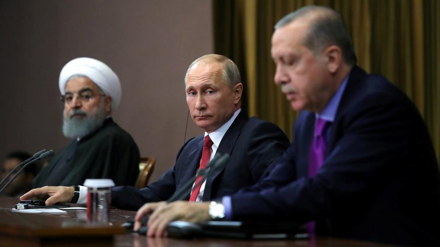 Iran's President Hassan Rouhani together with his counterparts Russia's Vladimir Putin and Turkey's Tayyip Erdogan attend a joint news conference following their meeting in Sochi, Russia November 22, 2017. Sputnik/Mikhail Klimentyev/Kremlin via REUTERS ATTENTION EDITORS - THIS IMAGE WAS PROVIDED BY A THIRD PARTY. - RC11C14BA4C0