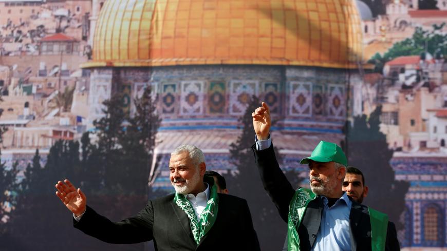 Hamas Chief Ismail Haniyeh and Gaza's Hamas Chief Yehya Al-Sinwar gesture to supporters during a rally marking the 30th anniversary of Hamas' founding, in Gaza City December 14, 2017. REUTERS/Mohammed Salem - RC1F66142030