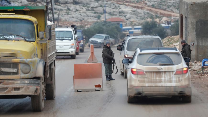 Armed men are seen at a check point in the border town of Al-Bab, near the Syrian-Turkish border, in Idlib province, Syria January 17, 2018. Picture taken January 17, 2018. REUTERS/Osman Orsal - RC1530487E20