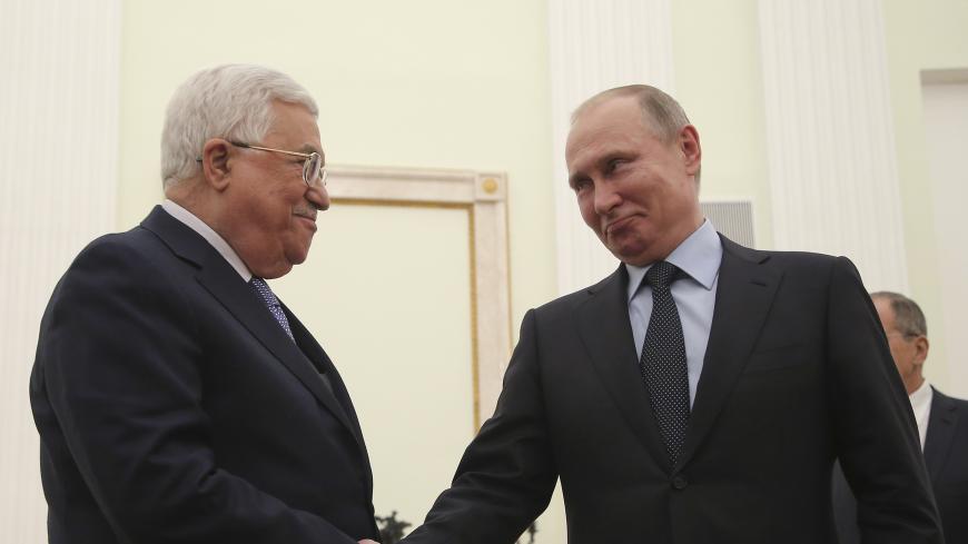 Russian President Vladimir Putin (R) shakes hands with Palestinian President Mahmoud Abbas during a meeting at the Kremlin in Moscow, Russia February 12, 2018. REUTERS/Maxim Shipenkov/Pool - UP1EE2C1ID90J