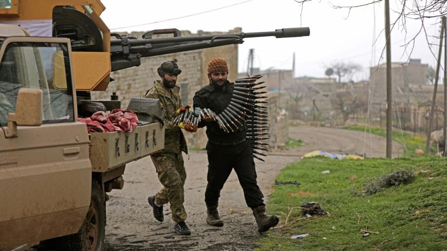 Turkish-backed Free Syrian Army fighters hold an ammunition belt near the city of Afrin, Syria February 21, 2018. REUTERS/Khalil Ashawi - RC14862D45C0