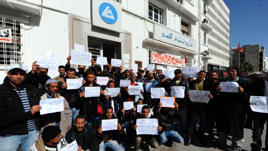Unemployed tunisians sit outside the headquarters of the Phosphate Gafsa Company (CPG) in hopes of employment in the local mines of Metlaoui on February 16, 2011. The phosfate mines of Gafsa, in the central-ouestern region of Tunisia are paralized by a civil demonstration for employment blocking acces to the mines. AFP PHOTO / FETHI BELAID (Photo credit should read FETHI BELAID/AFP/Getty Images)