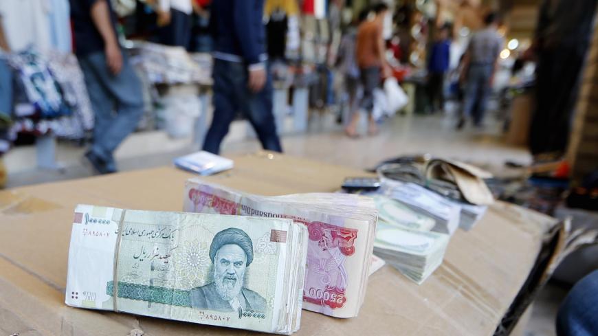 Iranian rial banknotes bearing a portrait of the late founder of the Islamic Republic of Iran, Ayatollah Ruhollah Khomeini, sit on the stand of an Iraqi money dealer on June 19, 2014, in Arbil, the capital of the autonomous Kurdish region of northern Iraq. President Hassan Rouhani said on June 18 Iran would do whatever it takes to protect revered Shiite shrines in Iraq against Sunni militants fighting the Baghdad government. AFP PHOTO/KARIM SAHIB        (Photo credit should read KARIM SAHIB/AFP/Getty Images