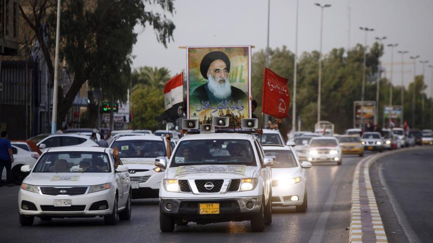 A portrait of Shiite cleric Grand Ayatollah Ali al-Sistani is seen in the city of Najaf on July 11, 2017 as Iraqis take to the streets to celebrate a day after the government's announcement of the "liberation" of the embattled city of Mosul. 
Prime Minister Haider al-Abadi declared Mosul finally retaken on July 10, as his forces fought to recapture a last sliver of territory still held by the jihadists in the Old City on the west bank of the Tigris River. / AFP PHOTO / Haidar HAMDANI        (Photo credit sh
