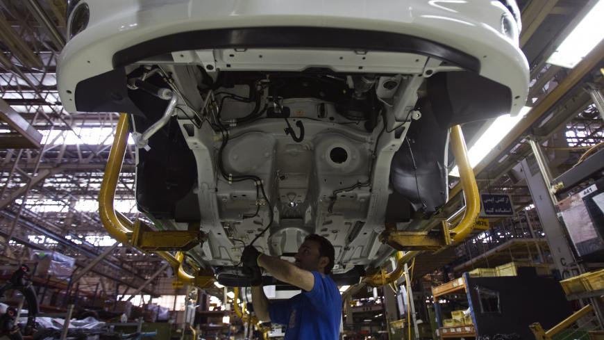 EDITORS' NOTE: Reuters and other foreign media are subject to Iranian restrictions on their ability to film or take pictures in Tehran. 
A worker assembles a vehicle at a production line of carmaker Iran Khodro, west of Tehran June 20, 2011. Iran Khodro, Iran's biggest car maker which runs what it says is the largest car factory in the Middle East, sees sales rising at home and abroad, despite economic sanctions on the Islamic Republic.  REUTERS/Morteza Nikoubazl (IRAN - Tags: TRANSPORT BUSINESS) - GM1E76K1