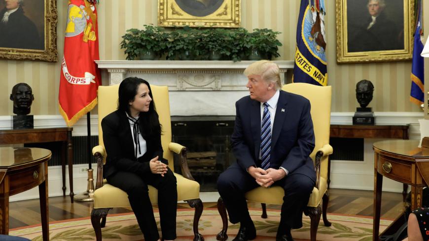 Aya Hijazi, an Egyptian-American woman detained in Egypt for nearly three years on human trafficking charges, meets with U.S. President Donald Trump in the Oval Office of the White House in Washington, U.S., April 21, 2017. REUTERS/Kevin Lamarque - RC15FBA0C5D0