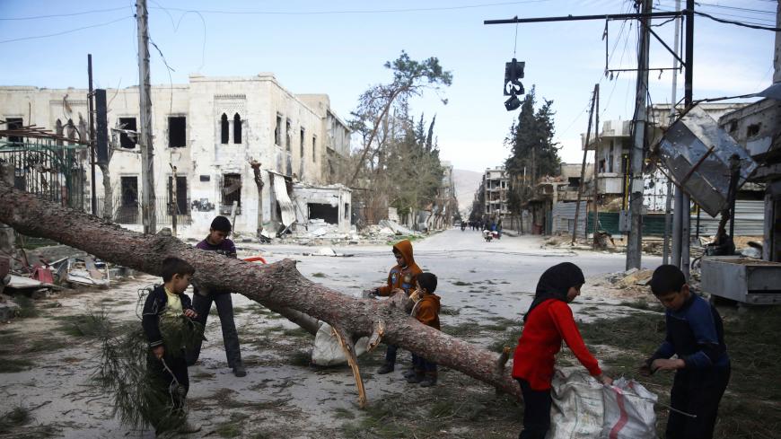 Children gather wood in the besieged town of Douma, Eastern Ghouta, in Damascus, Syria March 9, 2018. REUTERS/Bassam Khabieh - RC1A2DB1AA20
