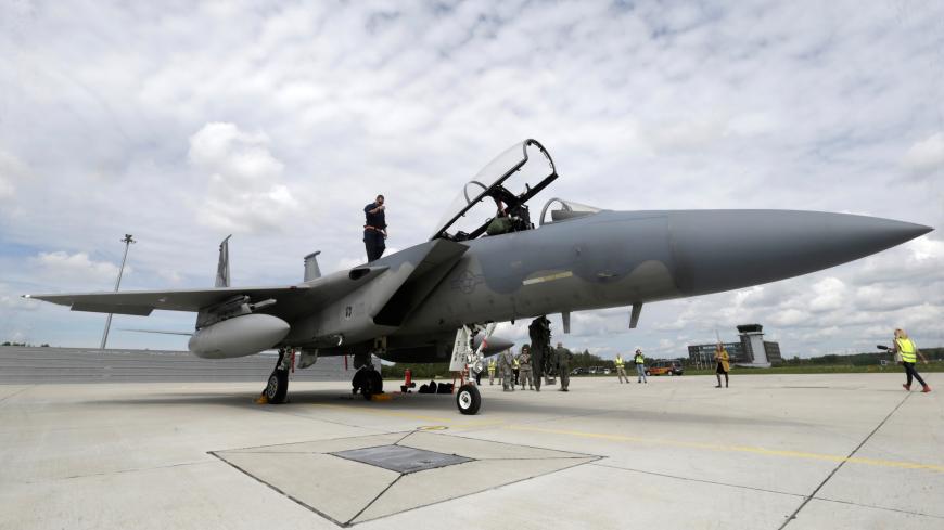 A specialist inspects a U.S Air Force F-15 Eagle fighter after a certification of the arresting gear in the military air base in Lielvarde, Latvia, May 19, 2016. REUTERS/Ints Kalnins - D1AETEYRKSAA