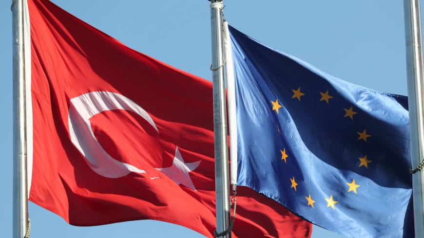 European Union (R) and Turkish flags fly at the business and financial district of Levent in Istanbul, Turkey September 4, 2017. REUTERS/Osman Orsal - RC18AEBF7100