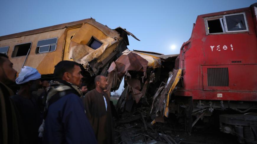 Rescue workers look at the wreckage after a train crash in Kom Hamada in the northern province of Beheira, Egypt, February 28, 2018.   REUTERS/Mohamed Abd El Ghany - RC1E21EBBA90