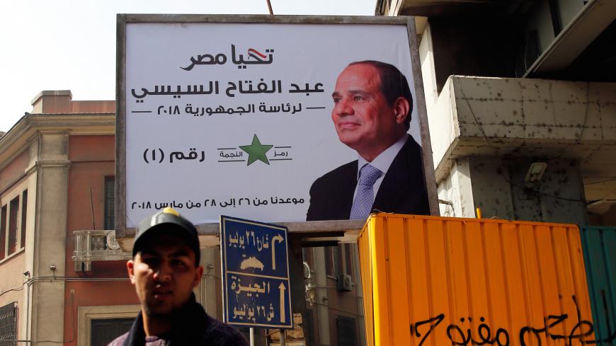 People walk by a poster of Egypt's President Abdel Fattah al-Sisi for the upcoming presidential election, in Cairo, Egypt March 1, 2018. REUTERS/Amr Abdallah Dalsh - RC1803270830