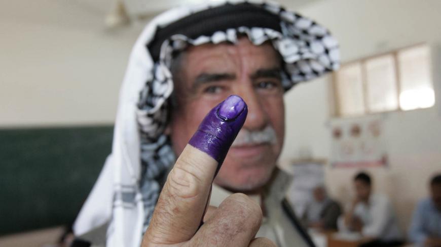 An internally displaced Iraqi man shows his ink-stained finger to the media after voting at a polling centre during the country's provincial elections in Kirkuk, 250 km (155 miles) north of Baghdad, April 20, 2013. Iraqis voted for provincial councils on Saturday in their first ballot since U.S. troops left the country, a key measure of political strength before parliamentary elections next year. Iraqi politics are deeply split along sectarian lines with Prime Minister Nuri al-Maliki's government mired in c
