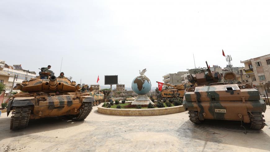 Turkish soldiers gather in the Kurdish-majority city of Afrin in northwestern Syria after seizing control of it from Kurdish People's Protection Units (YPG) on March 18, 2018.
Turkish-backed rebels have seized the centre of Afrin city in northern Syria, Ankara said, as they made rapid gains in their campaign against Kurdish forces. A civilian inside Afrin said that rebels had deployed in the city centre and that the YPG militia had withdrawn. / AFP PHOTO / OMAR HAJ KADOUR        (Photo credit should read OM