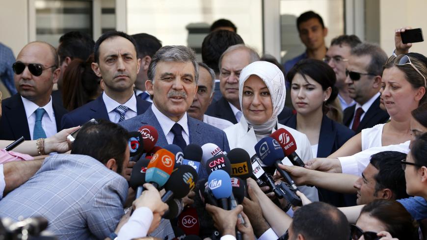Turkey's incumbent President Abdullah Gul and his wife Hayrunnisa Gul talk to the media as they leave a polling station after casting their votes in Ankara August 10, 2014. Turks began voting on Sunday with Tayyip Erdogan poised to become the country's first elected president, fulfilling his dream of what he calls a "new Turkey" and his opponents say will be an increasingly authoritarian nation. REUTERS/Umit Bektas (TURKEY - Tags: POLITICS ELECTIONS) - GM1EA8A1K7X01