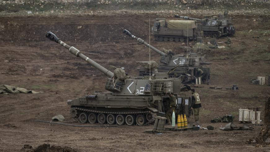Israeli soldiers stand next to mobile artillery units near the border with Syria in the Golan Heights January 27, 2015. At least two rockets from Syria hit the Israeli-occupied Golan Heights on Tuesday and Israel returned fire, the military said, nine days after an Israeli air strike in Syria killed an Iranian general and several Lebanese Hezbollah guerrillas. REUTERS/Baz Ratner (MILITARY POLITICS CIVIL UNREST) - GM1EB1S00W201