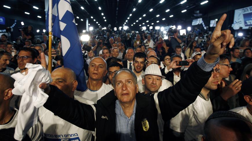Likud party supporters listen to Israeli Prime Minister Benjamin Netanyahu (not pictured) deliver a speech in Tel Aviv March 18, 2015. Netanyahu claimed victory in Israel's election after exit polls showed he had erased his center-left rivals' lead with a hard rightward shift in which he abandoned a commitment to negotiate a Palestinian state. REUTERS/Amir Cohen (ISRAEL - Tags: POLITICS ELECTIONS TPX IMAGES OF THE DAY) - GM1EB3I0N1J01