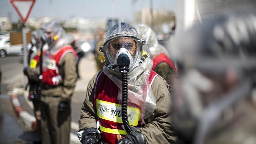 An Israeli Defence Force (IDF) reservist from the Home Front Command wears a protective suit during an exercise, together with hospital staff, simulating a chemical warfare attack at the Wolfson Hospital in Holon near Tel Aviv March 26, 2015. REUTERS/Baz Ratner 
      TPX IMAGES OF THE DAY           TPX IMAGES OF THE DAY      - GF10000039107