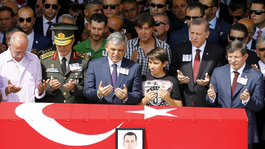 Turkey's President Tayyip Erdogan (2nd R), Prime Minister Ahmet Davutoglu (R), former President Abdullah Gul (4th R) and Chief of Staff General Hulusi Akar (2nd L) attend the funeral of Fehmi Sahin and Ali Koc, two of the 14 police officers who were killed during Tuesday's bombing in Igdir province in eastern Turkey, at Kocatepe Mosque in Ankara, Turkey, September 9, 2015. Daily clashes between Kurdish militants and security forces in southeast Turkey have cast doubt on whether a credible election can be he