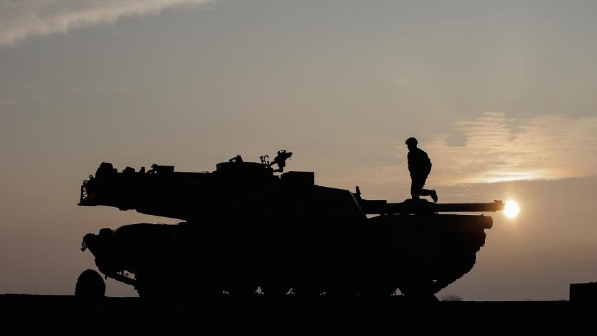 US soldiers prepare a M1 Abrams tank to offload from a train at the Mihail Kogalniceanu Air Base,  Romania, February 14, 2017. Inquam Photos/Octav Ganea/via REUTERS ATTENTION EDITORS - THIS IMAGE WAS PROVIDED BY A THIRD PARTY. EDITORIAL USE ONLY. ROMANIA OUT. NO COMMERCIAL OR EDITORIAL SALES IN ROMANIA - RC1DF190B4D0
