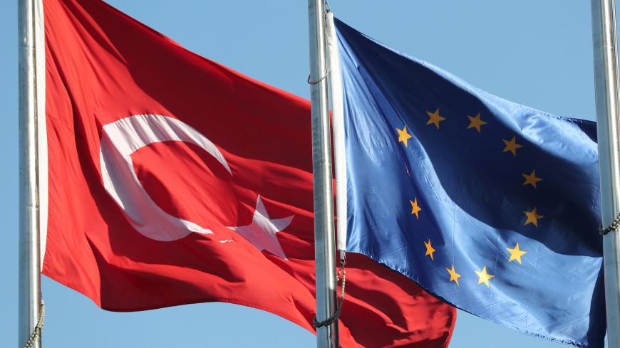 European Union (R) and Turkish flags fly at the business and financial district of Levent in Istanbul, Turkey September 4, 2017. REUTERS/Osman Orsal - RC18AEBF7100