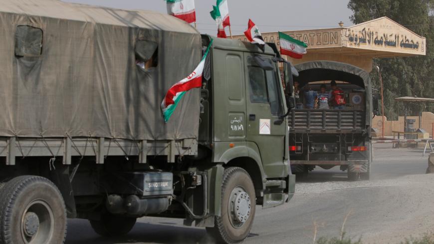 Iranian and Syrian flags flutter on a truck carrying humanitarian aid in Deir al-Zor, Syria September 20, 2017. Picture taken September 20, 2017. REUTERS/Omar Sanadiki - RC1C8E382200