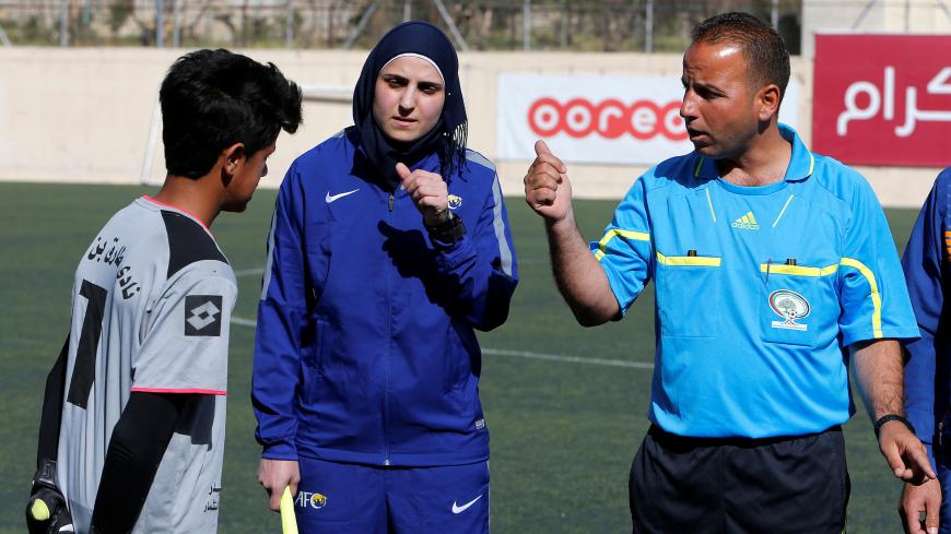 Female Palestinian football referee Yasmeen Nayroukh, 29, the only one accredited to run all-male games in the West Bank, prepares before a local soccer match in Hebron, in the occupied West Bank February 26, 2018. Picture taken March 26, 2018. REUTERS/Mussa Qawasma - RC1FE9E2BD90
