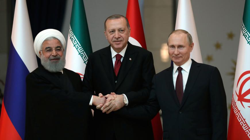 Presidents Hassan Rouhani of Iran, Tayyip Erdogan of Turkey and Vladimir Putin of Russia pose before their meeting in Ankara, Turkey April 4, 2018. Tolga Bozoglu/Pool via Reuters - RC1BFF99A690
