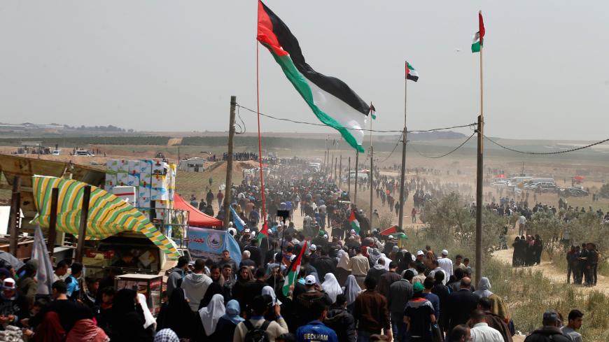 Palestinians take part in a protest demanding the right to return to their homeland, at the Israel-Gaza border, east of Gaza City, April 13, 2018. REUTERS/Mohammed Salem - RC15BBF98CF0