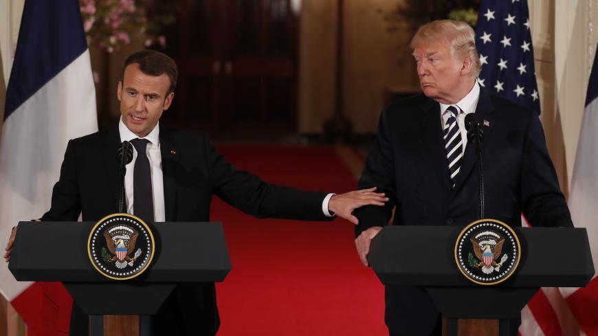 French President Emmanuel Macron reaches out to U.S. President Donald Trump as he speaks during their joint news conference at the White House in Washington, U.S., April 24, 2018. REUTERS/Jonathan Ernst - HP1EE4O1CL79F