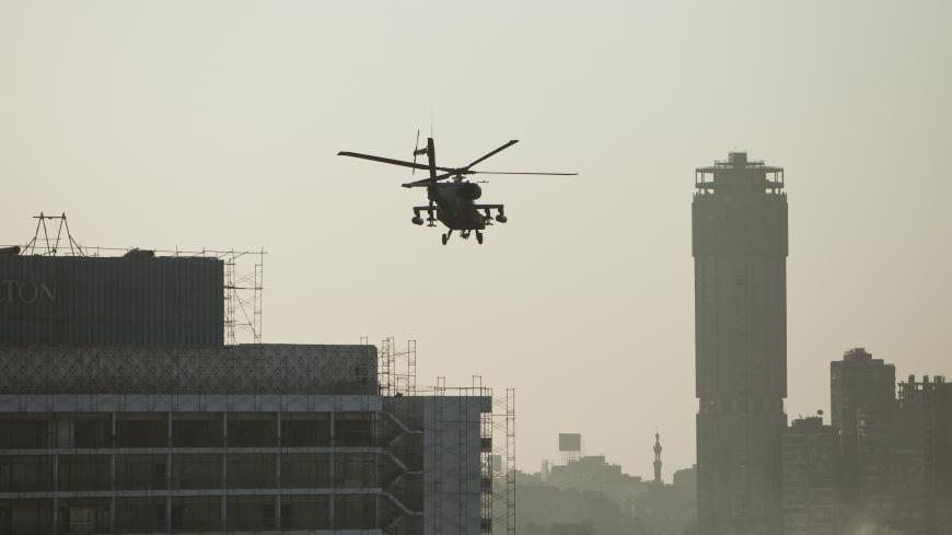 CAIRO, EGYPT - JULY 26:  An Egyptian Army Apache helicopter flies over the Cairo skyline during pro-military demonstrators at Tahrir Square on July 26, 2013 in Cairo, Egypt. Protesters gathered to show support to the overthrow of Egyptian President Mohammed Morsi by the Egyptian military on July 3, after a speech made Wednesday by the Chief of Egypt's Armed Forces, General Ahmed Fattah al-Sissi, who called for mass anti-Morsi protests across Egypt on Friday against 'violence and terrorism'. Egyptian authori