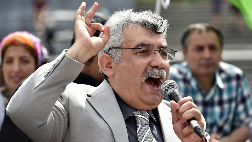 Zubeyir Aydar, president of the People's Congress of Kurdistan, addresses Kurdish protesters during a demonstration against alleged attacks perpetrated by the Turkish army against Kurds, in Brussels on August 8, 2015. Ankara has launched a two-pronged "anti-terror" offensive against jihadists in Syria and PKK militants based in northern Iraq after a series of attacks on Turkish soil, including a suicide bombing blamed on IS that killed 32 pro-Kurdish activists in the town of Suruc. The PKK, which accuses th