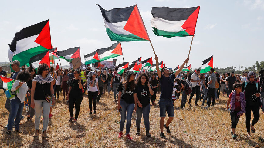 Palestinian and Arab Israeli protesters wave Palestinian flags as they march for the right of return for Palestinian refugees who fled their homes or were expelled during the 1948 war that followed the creation of the state of Israel, during the 70th anniversary of the Jewish state's founding, near Haifa in northern Israel, on April 19, 2018. (Photo by AHMAD GHARABLI / AFP)        (Photo credit should read AHMAD GHARABLI/AFP/Getty Images)