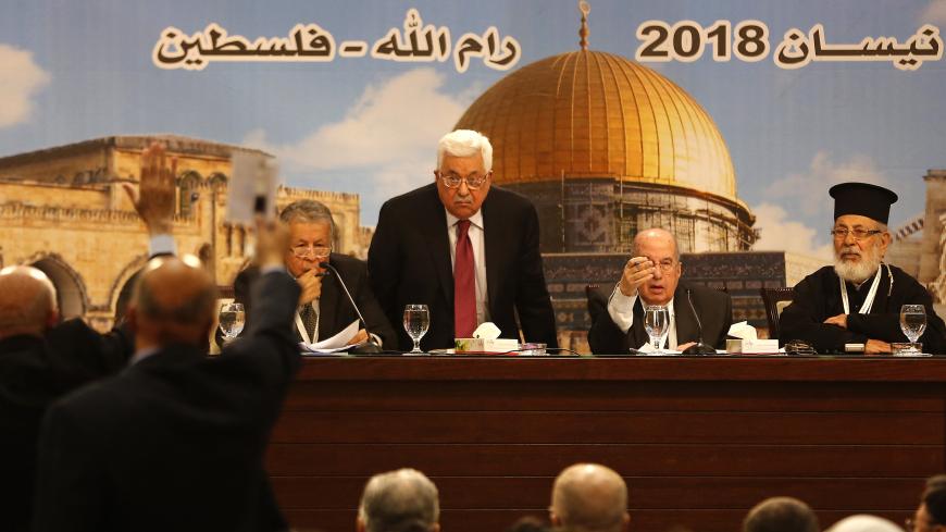 Palestinian president Mahmud Abbas (C) chairs a Palestinian National Council meeting in Ramallah on April 30, 2018. - Abbas called today for Palestinians to keep their children from protests along the border between Israel and Gaza, warning of a "handicapped" generation. "Keep the young men from the border, move the children away, we do not want to become handicapped people," he said in a speech in the West Bank city of Ramallah, while supporting what he called "peaceful" protests. (Photo by ABBAS MOMANI / 