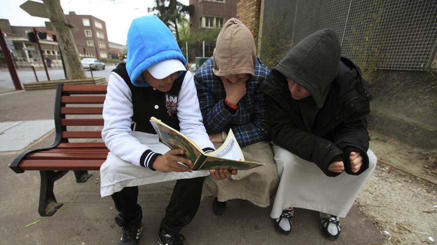 Teenagers read the Koran in Paris March 31, 2012. Picture taken March 31, 2012.     REUTERS/Zohra Bensemra (FRANCE - Tags: SOCIETY RELIGION) - GM1E8421QDA01