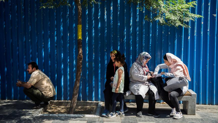 Iranian women sit on street bench in Tehran, Iran, August 2, 2017. Nazanin Tabatabaee Yazdi/TIMA via REUTERS ATTENTION EDITORS - THIS IMAGE WAS PROVIDED BY A THIRD PARTY. - RC1A3741D5D0