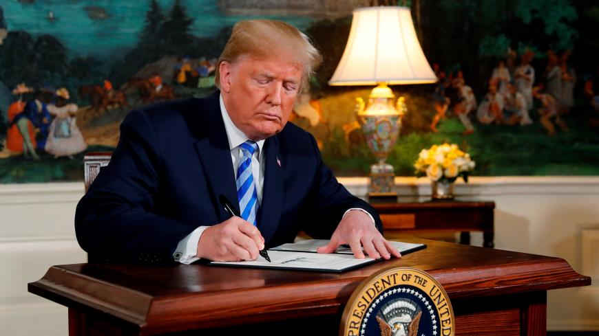 U.S. President Donald Trump signs a proclamation declaring his intention to withdraw from the JCPOA Iran nuclear agreement in the Diplomatic Room at the White House in Washington, U.S., May 8, 2018. REUTERS/Jonathan Ernst     TPX IMAGES OF THE DAY - RC157E042900