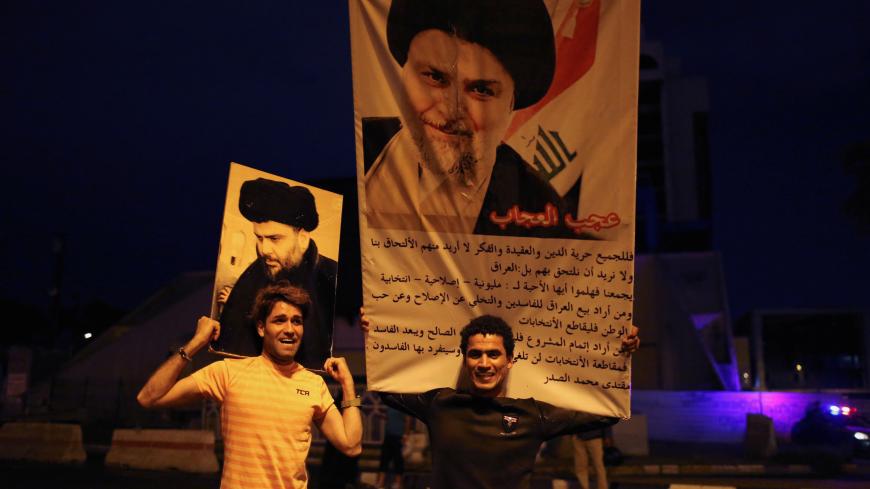 Iraqi supporters of Sairun list celebrate with portraits of Shi'ite cleric Moqtada al-Sadr, after results of Iraq's parliamentary election were announced in Baghdad, Iraq May 14, 2018. REUTERS/Thaier al-Sudani     TPX IMAGES OF THE DAY - RC1278A66440