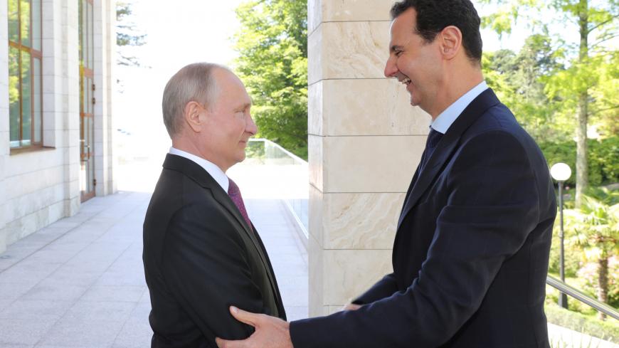 Russian President Vladimir Putin welcomes Syrian President Bashar al-Assad during their meeting in the Black Sea resort of Sochi, Russia May 17, 2018. Sputnik/Mikhail Klimentyev/Kremlin via REUTERS ATTENTION EDITORS - THIS IMAGE WAS PROVIDED BY A THIRD PARTY.     TPX IMAGES OF THE DAY - RC1158F50280