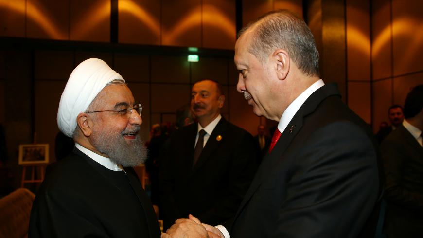 Turkish President Tayyip Erdogan meets with Iran's President Hassan Rouhani during an extraordinary meeting of the Organisation of Islamic Cooperation (OIC) in Istanbul, Turkey, December 13, 2017. REUTERS/Kayhan Ozer/Pool - RC1507ABA930